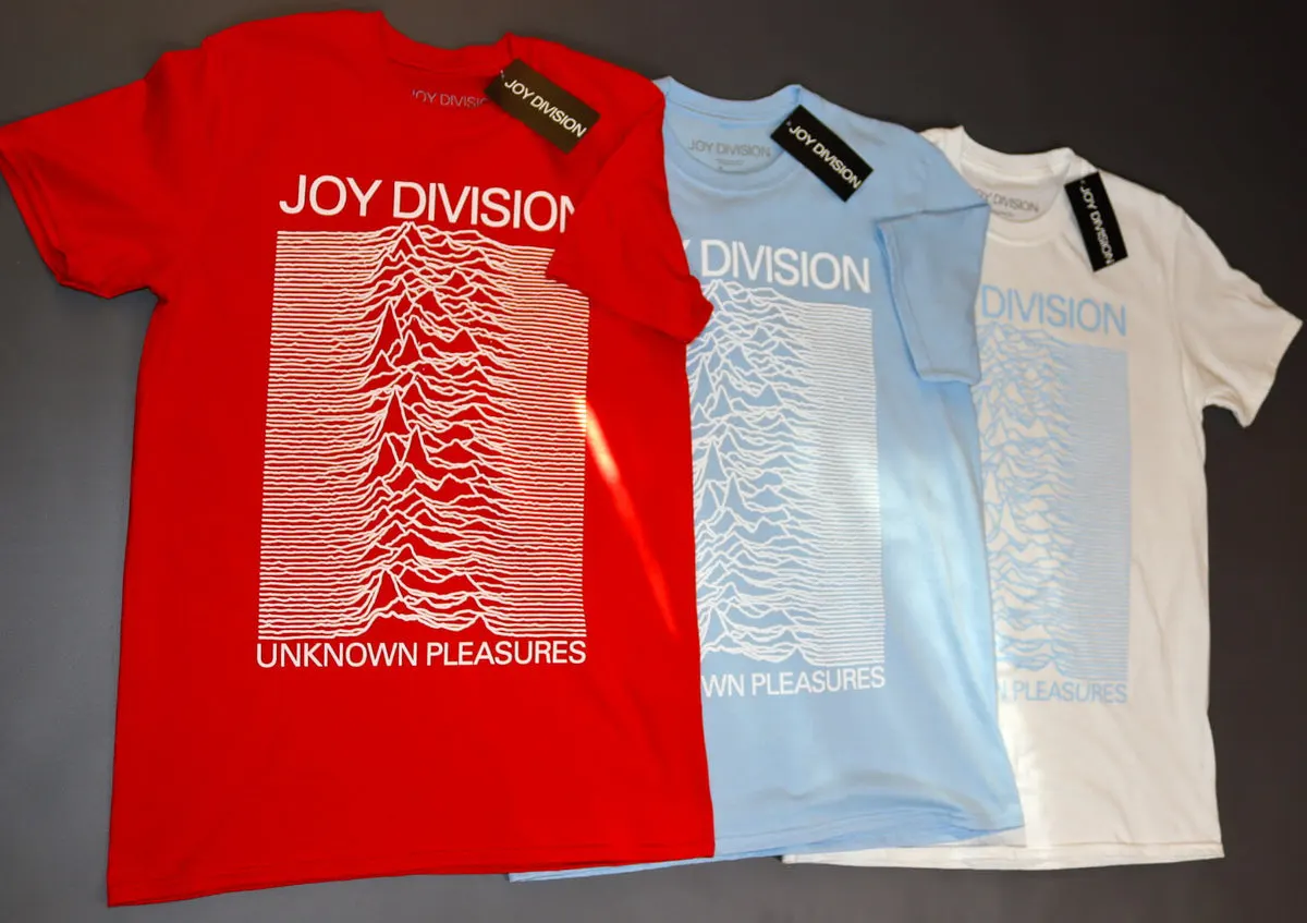 Folded Unknown Pleasures t-shirts in red, light blue and white with the Joy Division waves