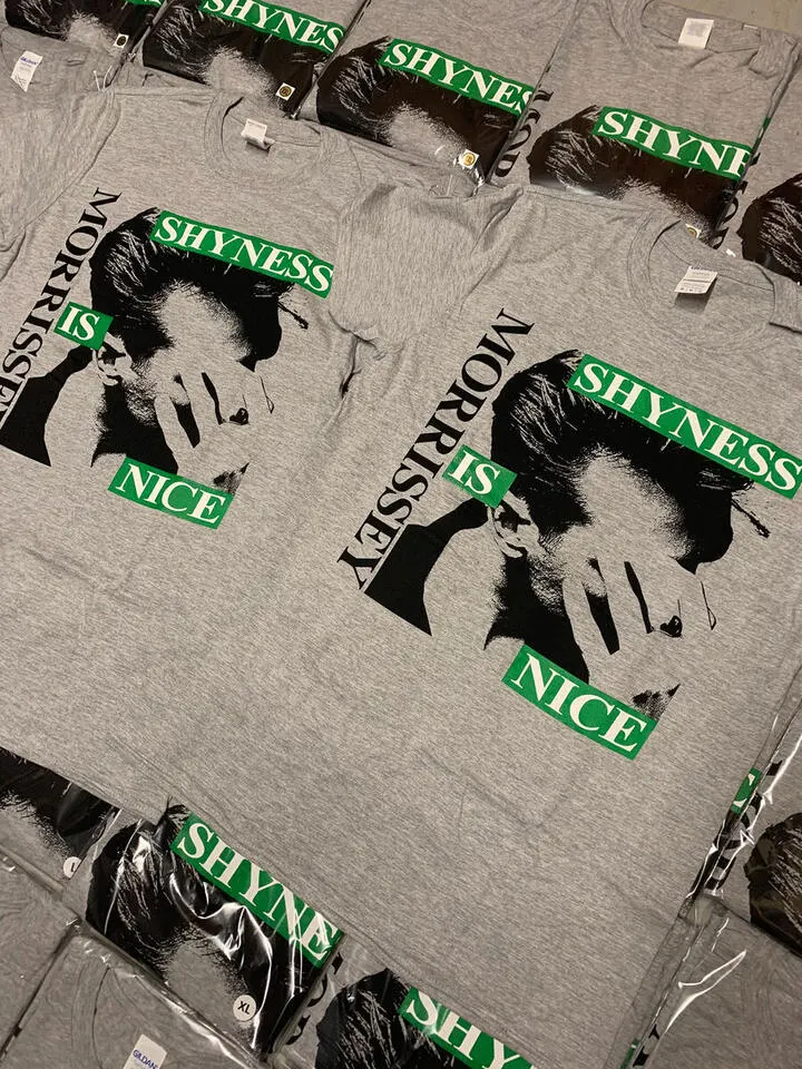 Pile of folded grey Morrissey Shyness Is Nice t-shirts