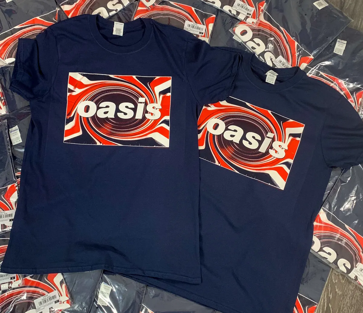 Two navy Oasis Union Jack t-shirts on a pile of folded shirts
